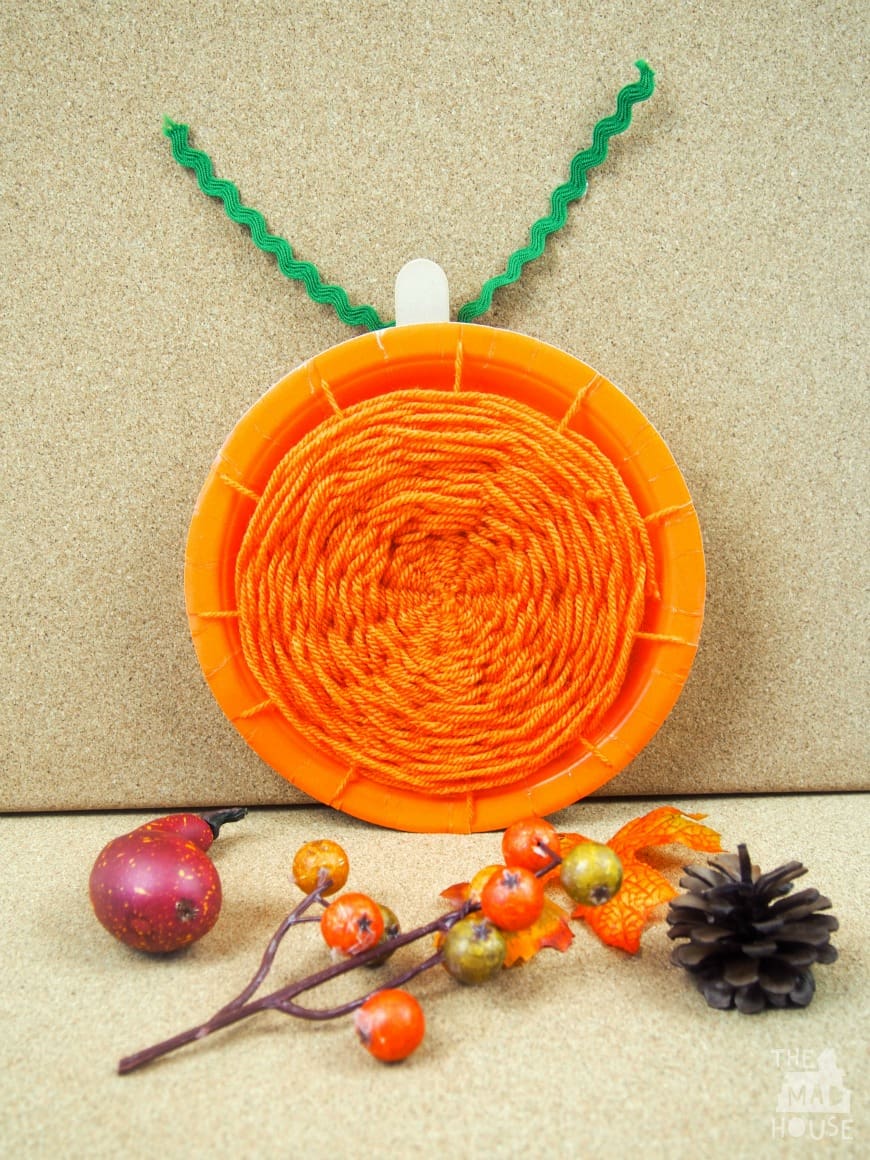Pumpkin paper plate weaving, a super simple weaving kids craft perfect for Autumn and Halloween