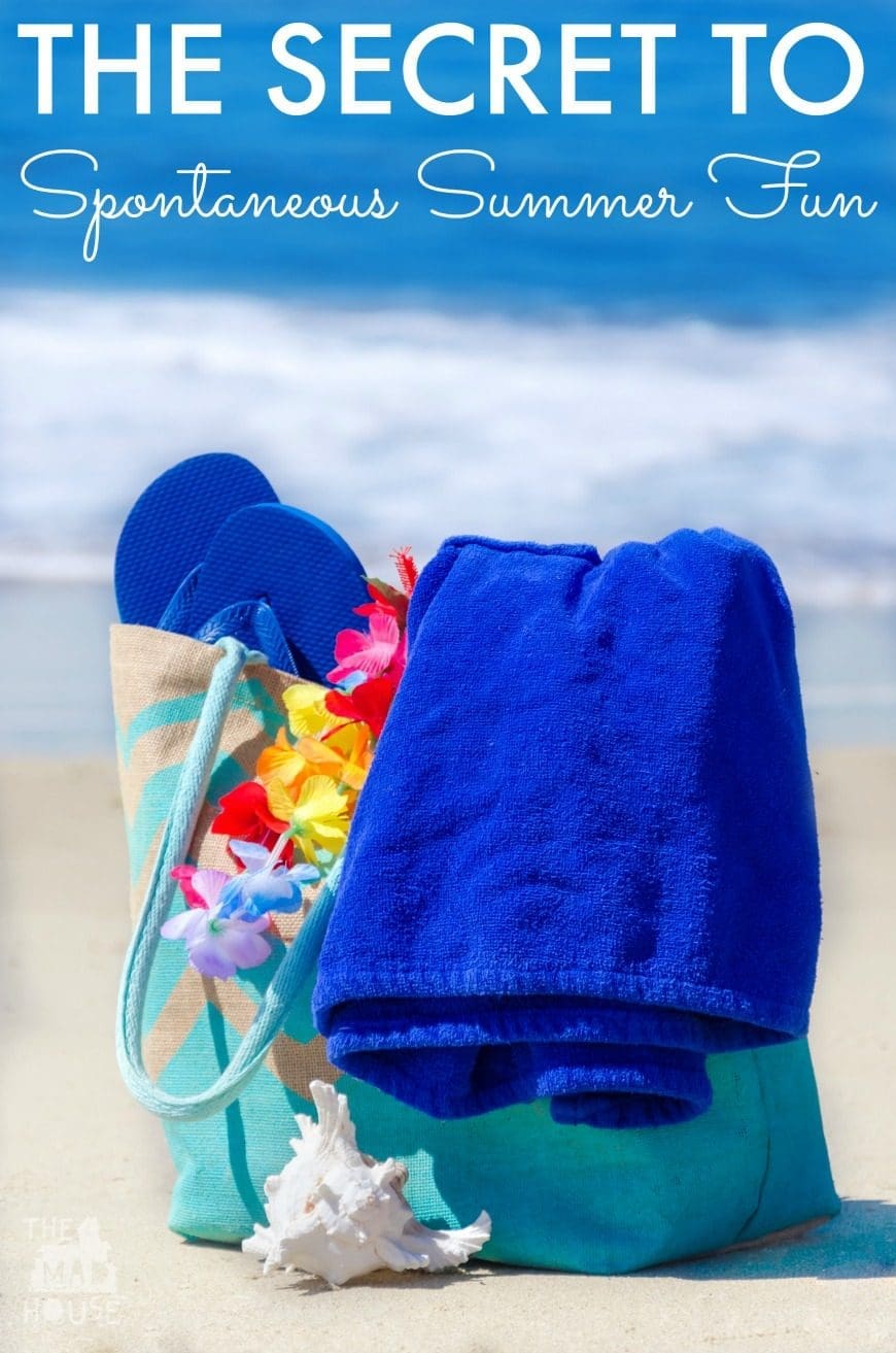Beach bag with seashell, flip flops, and towel by the ocean