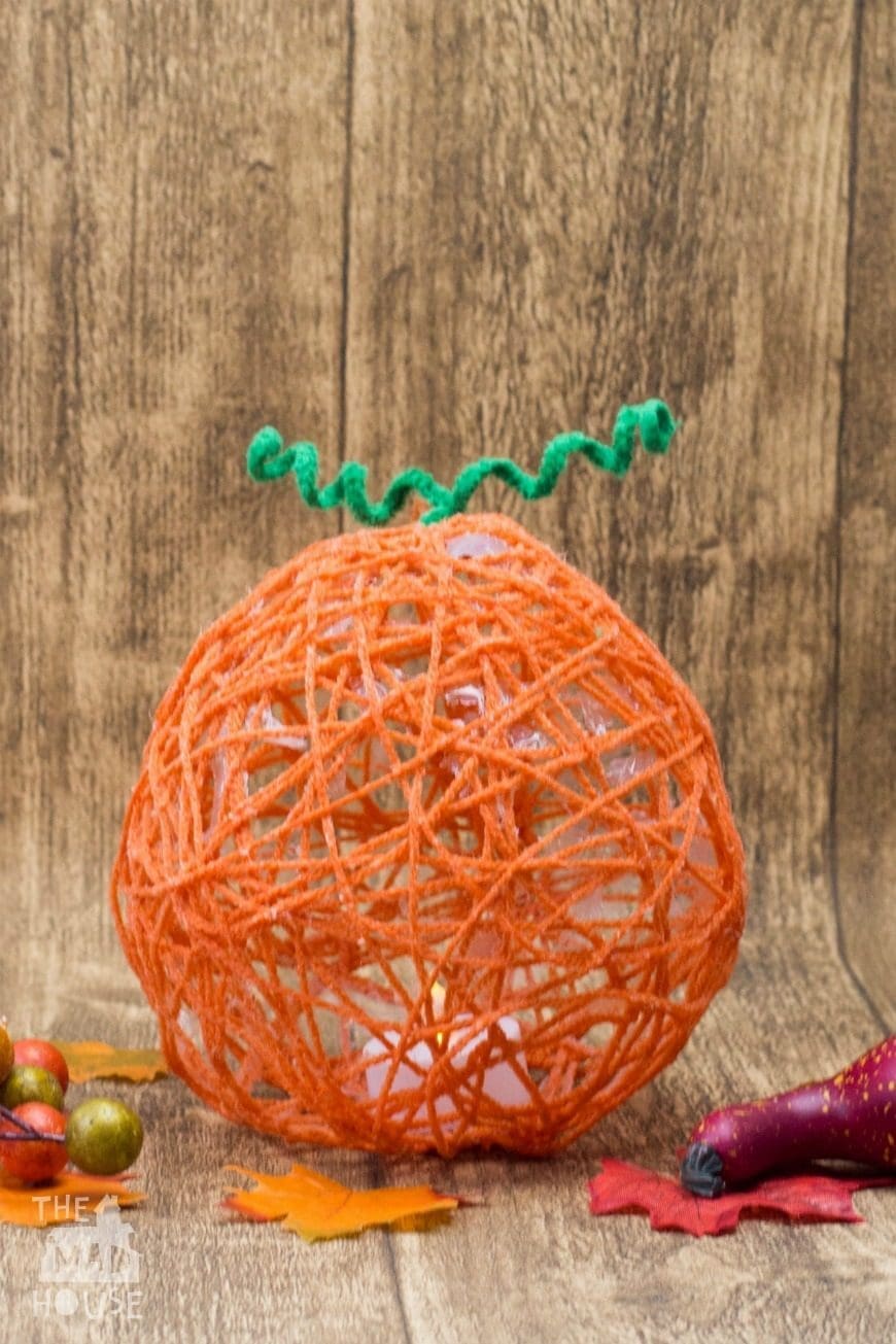 These yarn wrapped pumpkin lanterns are a fantastic fun hands-on art activity for kids. Celebrate the seasons with this autumnal craft. This is such a fun Fall themed process art activity for children.