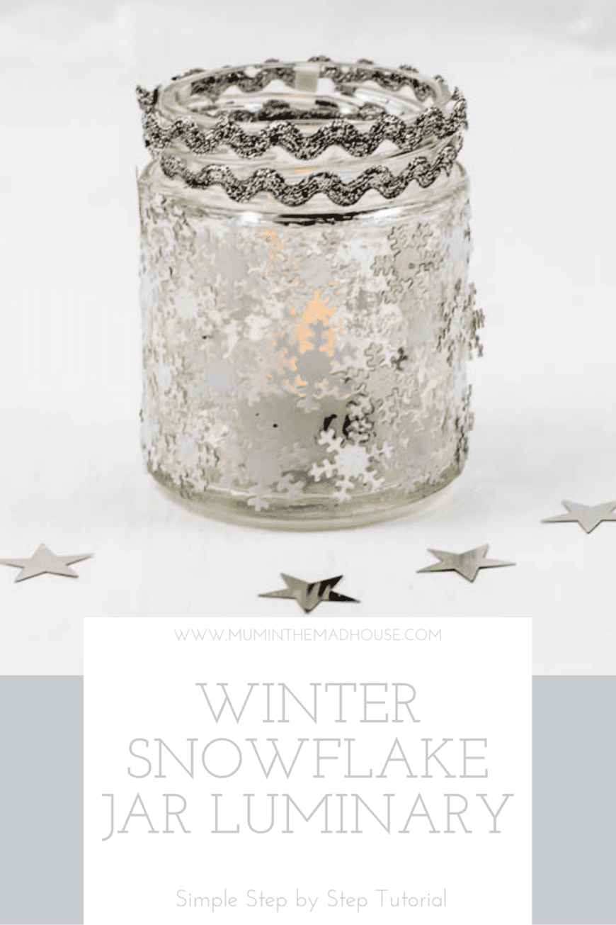 Glass jar with snowflake sequins on and two rows of silver rick rack on the top 