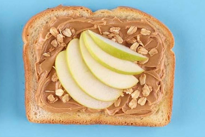 Apple, peanut butter and toasted oats on toast