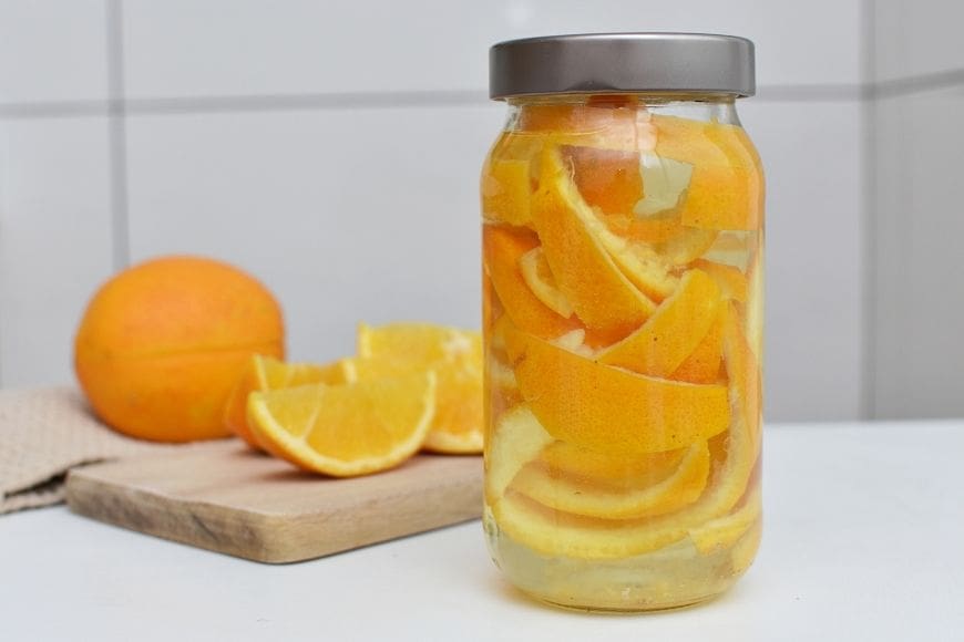 A Jar of orange peels and white vinegar 