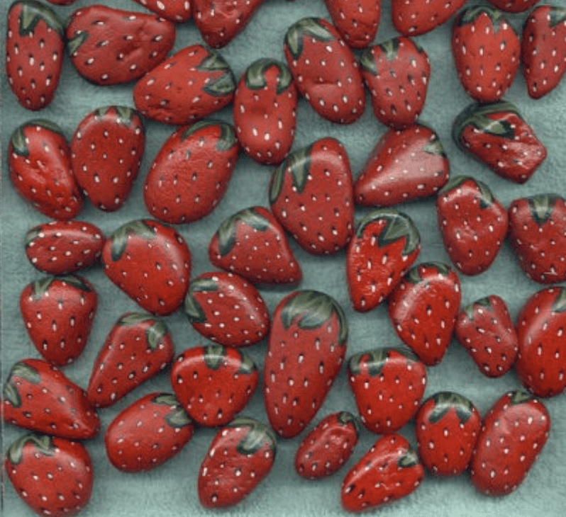 Rocks painted to look like strawberries 