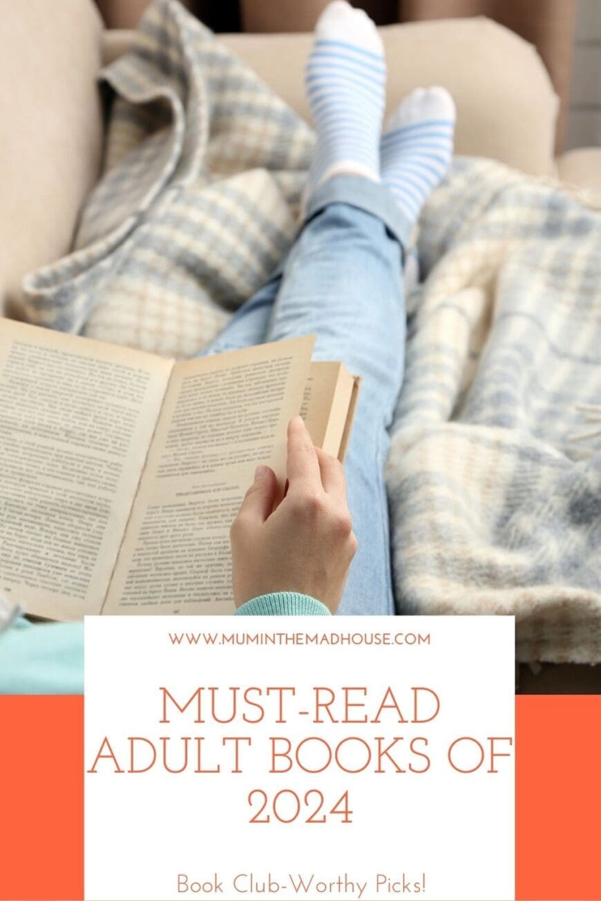 A person wearing blue jeans and striped socks relaxes on a couch, flipping through a book, wrapped in a cozy blanket. The text overlay reads 'Must-Read Adult Books of 2024 – Book Club-Worthy Picks!' from Mum in the Madhouse."