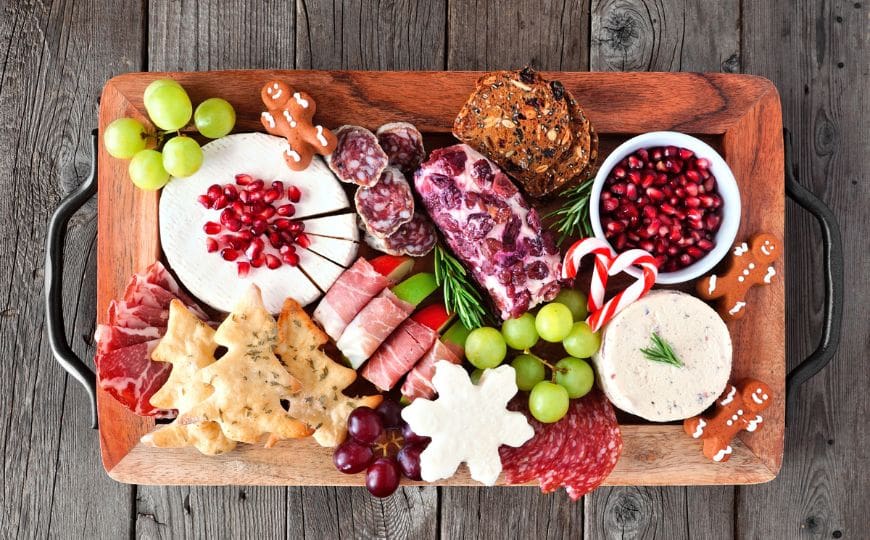 Eco-friendly Christmas snack board with seasonal fruits, cheese, and chutneys